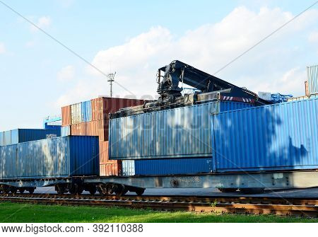 Shipping Container Loading By Richtracker On The Freight Rail Car At Logistic Warehouse Port. Ocean 