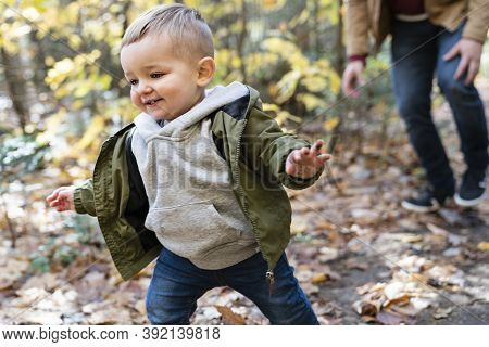 Son And Her Father In The Autumn Season In Park Play Hideout
