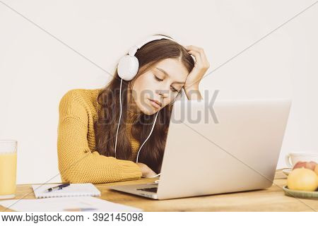Young Girl Fell Asleep In Front Of Laptop. Cute Woman Is Bored