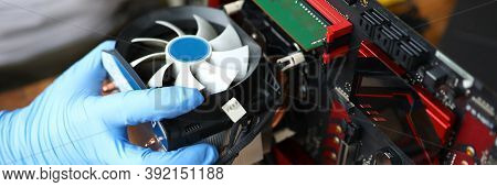 Close-up Of Middle-aged Man Repairing Detail Of Device. Technician Male Fixing Computer Mainboard. T