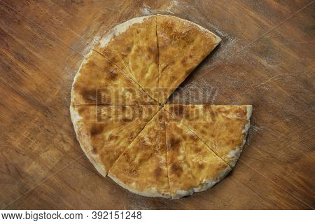 Baked homemade  cheese pie on wooden background. Bulgarian banitsa, Georgian khachapuri, Greek tirop
