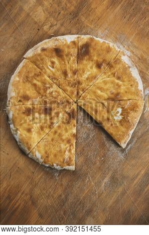 Baked homemade  cheese pie on wooden background. Bulgarian banitsa, Georgian khachapuri, Greek tirop