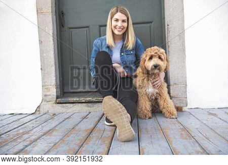 Labradoodle Dog And Woman Outside On Balcony