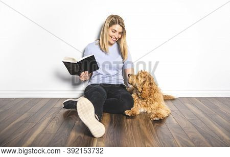 Woman With His Golden Labradoodle Dog Reading Book Isolated On White Background