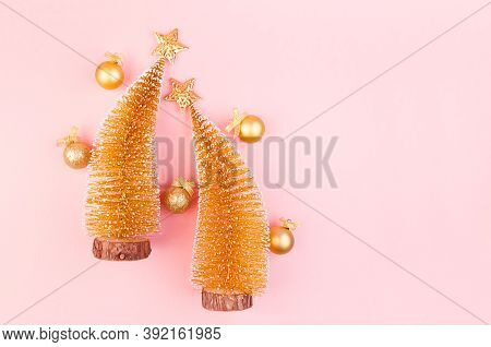 Golden Christmas Decorations With Christmas Trees, Stars, Balls On Soft Light Pink Background, Copy 