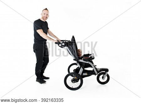 A Father Jogging With A Baby Stroller