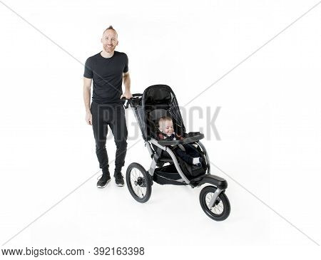 A Father Jogging With A Baby Stroller