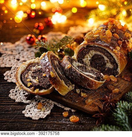 Christmas Poppy Seed Cake, Sliced Poppy Seed Cake Covered With Icing And Decorated With Raisins On T