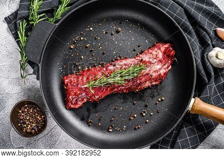 Raw Marbled Beef Steak, Fillet In A Pan With Ingredients For Cooking. Gray Background. Top View