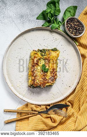 Baked Stuffed Vegetarian Pasta Cannelloni With Broccoli, Spinach, Basil And Cheese. Gray Background.