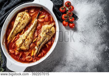 Cooking In Tomatoes Monkfish Fish In A Baking Dish. Fresh Seafood. Gray Background. Top View. Copy S