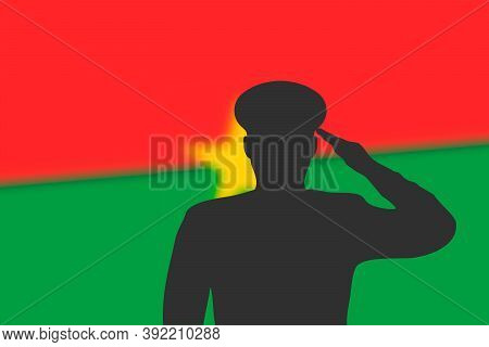 Solder Silhouette On Blur Background With Burkina Faso Flag.