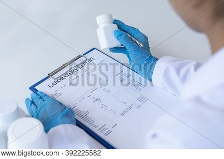 Closeup portrait, Scientists in white lab coats are analyzing the vital substance of the sample drug