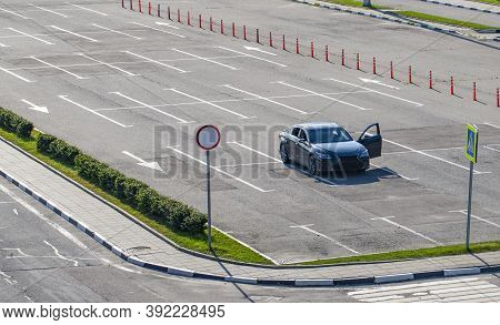 One Car With Open Door In The Parking Lot