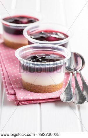 Sweet desssert. Cheesecake cup on pink napkin.