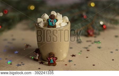 A Gingerman In A Mug With Hot Cocoa And Marshmallow. Christmas Holiday Decorations And Blurred Xmas 