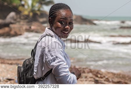 Happy African Girl With Backpack In Axim Ghana.