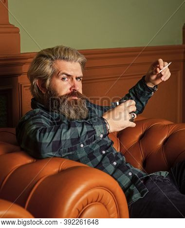 Smoke Cigarette While Drink Brandy Or Cognac. Hard Beverage For Real Men. Brutal Man Drinking Whiske