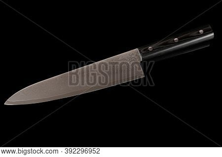 New unused chef knife isolated on black background