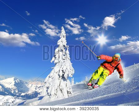 Skier skiing downhill in high mountains