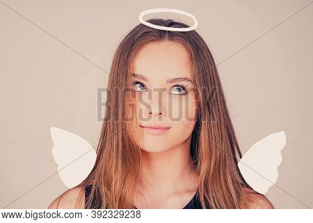 Angel. Child With Angelic Character. Lovely And Cute Youth. Girl Angel With Halo In White Angel Dres
