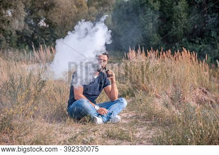 Stylish Vape Man Exhaling Vapor From Electronic Cigarette. Electronic Cigarette Concept.