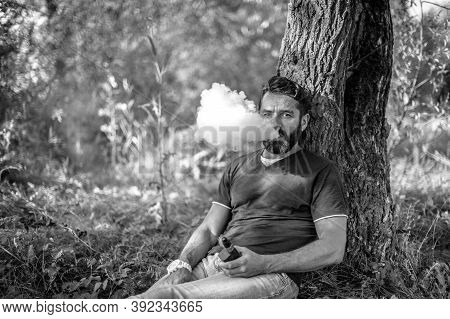 Stylish Vaper Using Electronic Cigarette To Vape Instead Of Smoking. Smoking Cessation Tobacco.