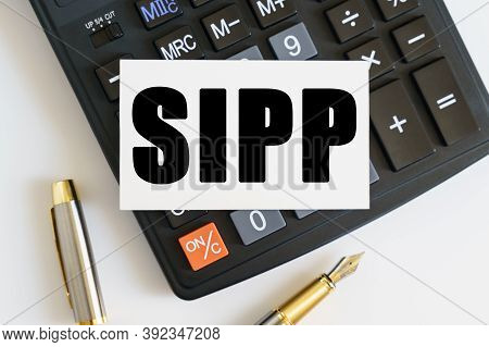 Business And Finance Concept. On The Table There Is A Pen, A Calculator And A Business Card On Which