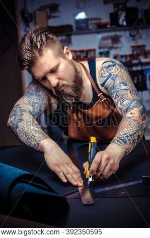 Artist Working With Leather Wording With Leather Goods At The Tanner Shop