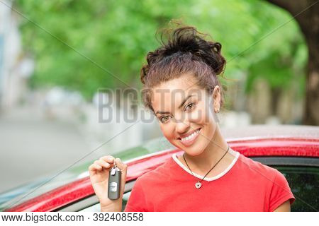 Young Beautiful Black Woman Driver Holding Showing Car Keys Her New Car Wearing Red Shirt Outdoors, 