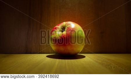 Bright Ripe Apple On A Background Of A Wooden Wall Close-up.