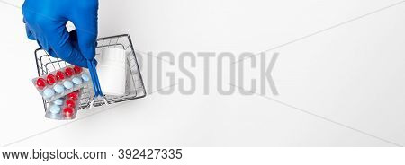 Shopping Metal Empty Basket In Male Hand In Blue Protecive Glove. Shopping During Coronavirus Lockdo
