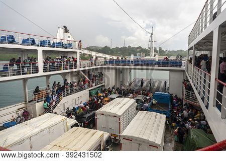 Zanzibar, Tanzania - 5 January 2020: Crowd Of Local Black Muslim African People Under Rain Are Waiti