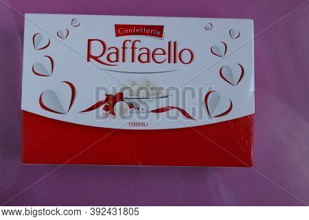 Raffaello\'s Square Rectangular Gift Box Stands On A Fuchsia Pink Background Side View Of Copy Space
