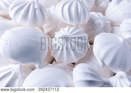 Background From White Airy And Tasty Bizet. White Meringue, Bizet Cakes On The Table.