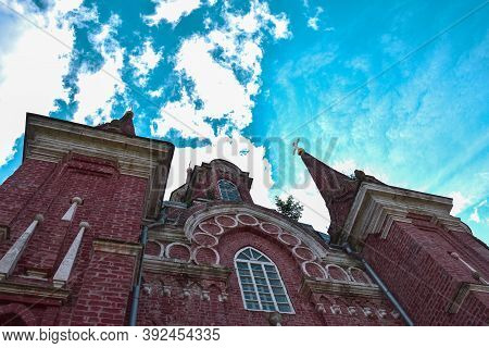 The Gothic Building Of The Church Of The Sign Of The Icon Of The Mother Of God Rises Into The Cloudy