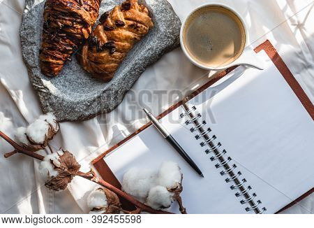 Coffee Mug With Croissant And Empty Notebook And Pencil For Business Plan And Design Ideas Onon Whit