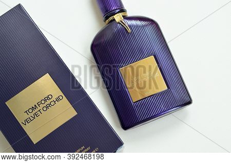 Tom Ford Velvet Orchid Fragrance Perfume Bottle Lies On Light Lilac Background. Tom Ford Is American