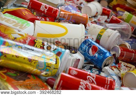 Many Wrappings And Cans From Used Products By Famous Worldwide Brands. Pattern Of Trash Of Various C