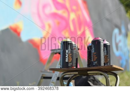Used Montana Black And Hardcore Aerosol Spray Cans Against Graffiti Paintings. Mtn Or Montana-cans I