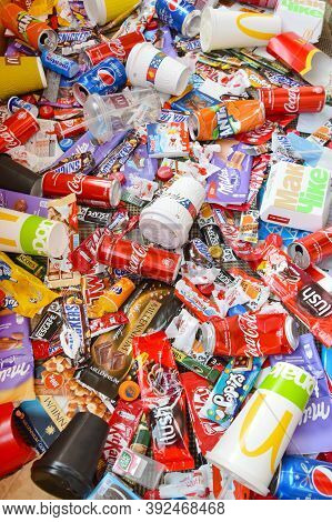 Many Wrappings And Cans From Used Products By Famous Worldwide Brands. Pattern Of Trash Of Various C