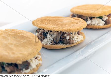 Three Gorditas Served With On A Long Plate Looks And Tastes Appealing.
