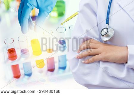Doctor And Microbiologist With Vacuum Tubes For Samples With Covid 19 Infection Atypical Pneumonia V
