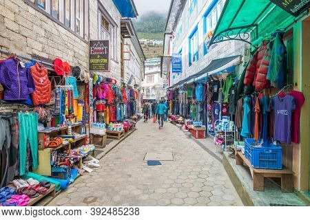Namche Bazaar, Nepal : October-14-2018 :  The Clothing And Souvenir Shops In The Main Street Of Namc
