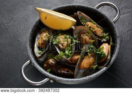 Classic French Meal Moules Marinière  Marinara Mussels With Garlic, Sauce, Lemon And Parsley.
