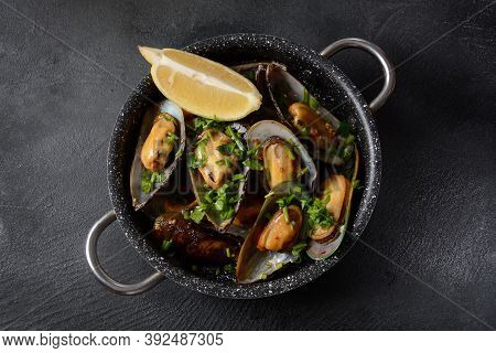 Classic French Meal Moules Marinière  Marinara Mussels With Garlic, Sauce, Lemon And Parsley.