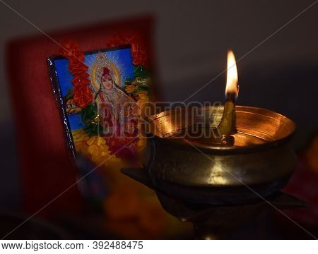 A Diya Or Lamp Is Illuminated In Front Of Hindu Goddess Laxmi During Laxmi Puja Festival. Laxmi Is A