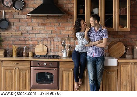 Happy Couple Renters Relax In New Renovated Home Kitchen