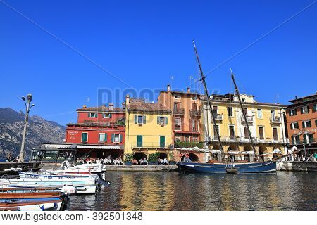 Malcesine, Italy - October 11:  The View Across Boats Moored In The Resort Town Of Malcesine To Cafe
