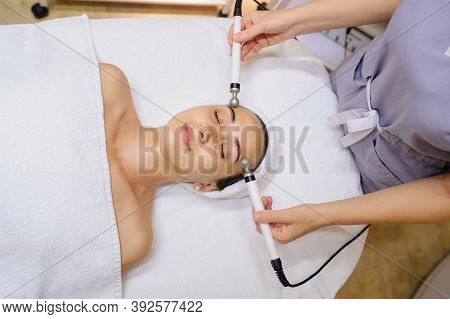 Woman Facial Massage Spa Procedure. Electric Stimulation Facial Skin Care. Microcurrent Lift Face. B